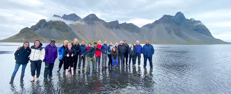 Arctic Adventures Crew Standing on Water in Front of Vesterhorn Mountain